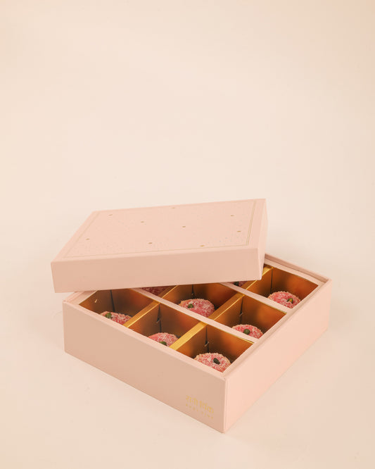 Our old-fashioned square mithai boxes come in the prettiest shades of powder pink and pista green, adorned with tiny embossed silver dots and delicate gold Mughal stars.

Thoughtfully designed for kaju katli, motichoor laddoos, and other Indian sweets, these traditional sweet boxes bring a little extra charm to festive gifting, weddings, intimate celebrations, and thoughtful gestures.

Beautifully wrapped treats, made for little celebrations and the pleasure of sending something sweet to someone you love.