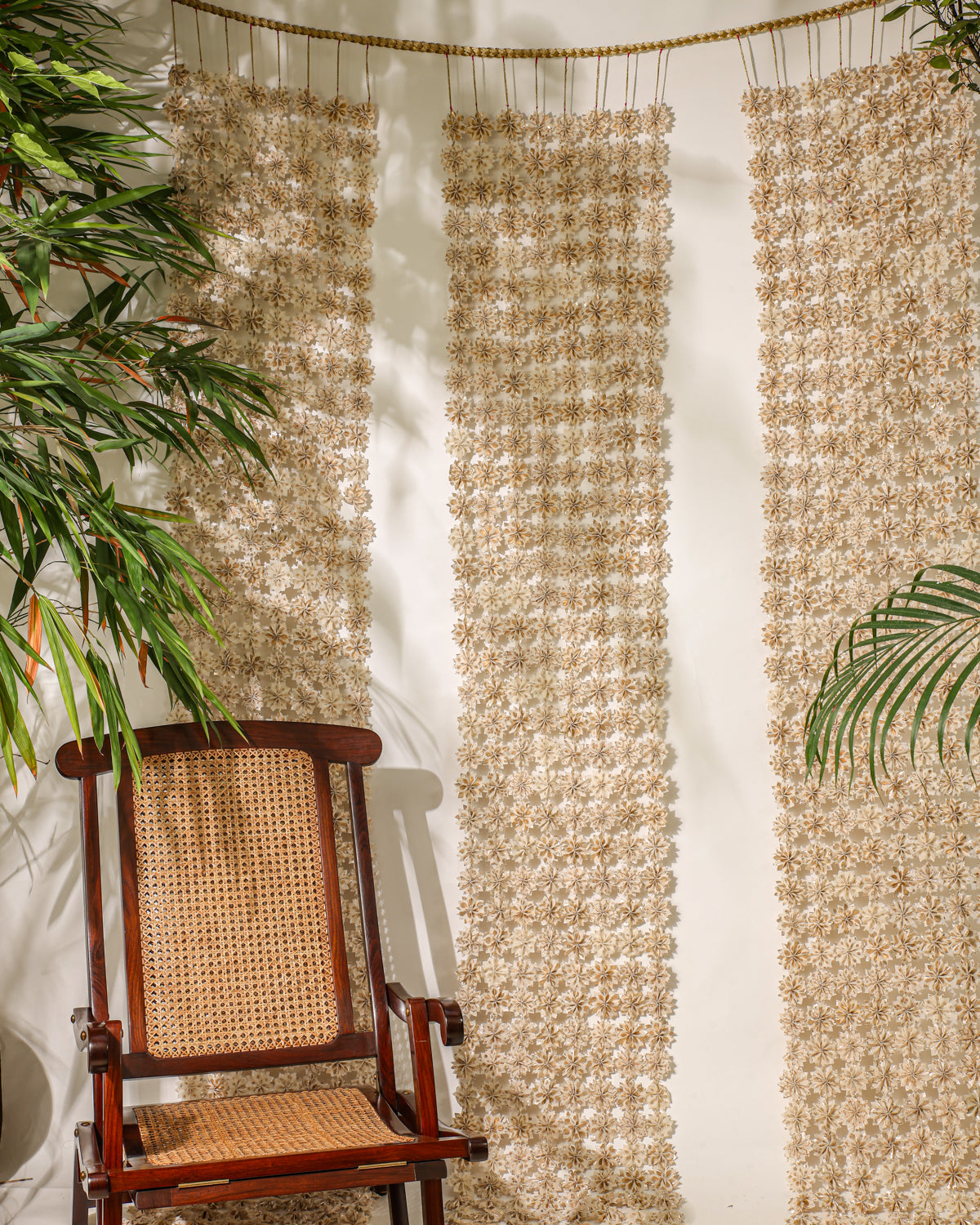 Inspired by the beauty of Raat ki Rani flowers, this handcrafted floral jaal is made from Rani Pink textile remnants, with individually handmade flowers joined by delicate zari knots. Finished with a hand-braided zari border, it is perfect for decorating doorways, walls, and festive spaces.