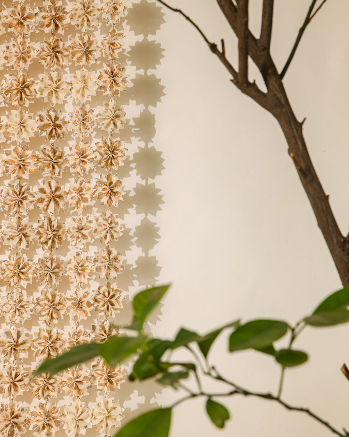 Inspired by the beauty of Raat ki Rani flowers, this handcrafted floral jaal is made from Rani Pink textile remnants, with individually handmade flowers joined by delicate zari knots. Finished with a hand-braided zari border, it is perfect for decorating doorways, walls, and festive spaces.