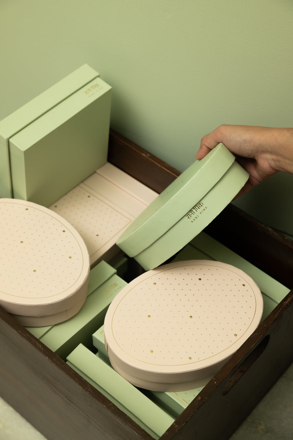 Inspired by old-fashioned mithai boxes, this oval paper sweets box comes in powder pink and pista green, adorned with embossed silver dots and delicate gold Mughal stars. Perfect for gifting mithai, festive treats, and celebrating special moments.